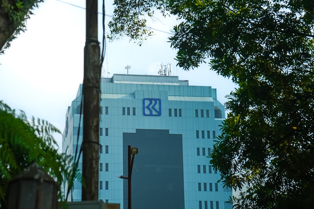Modern office building with blue facade and gray facade.