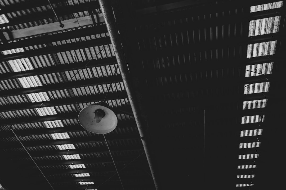 white round ceiling light turned on in grayscale photography