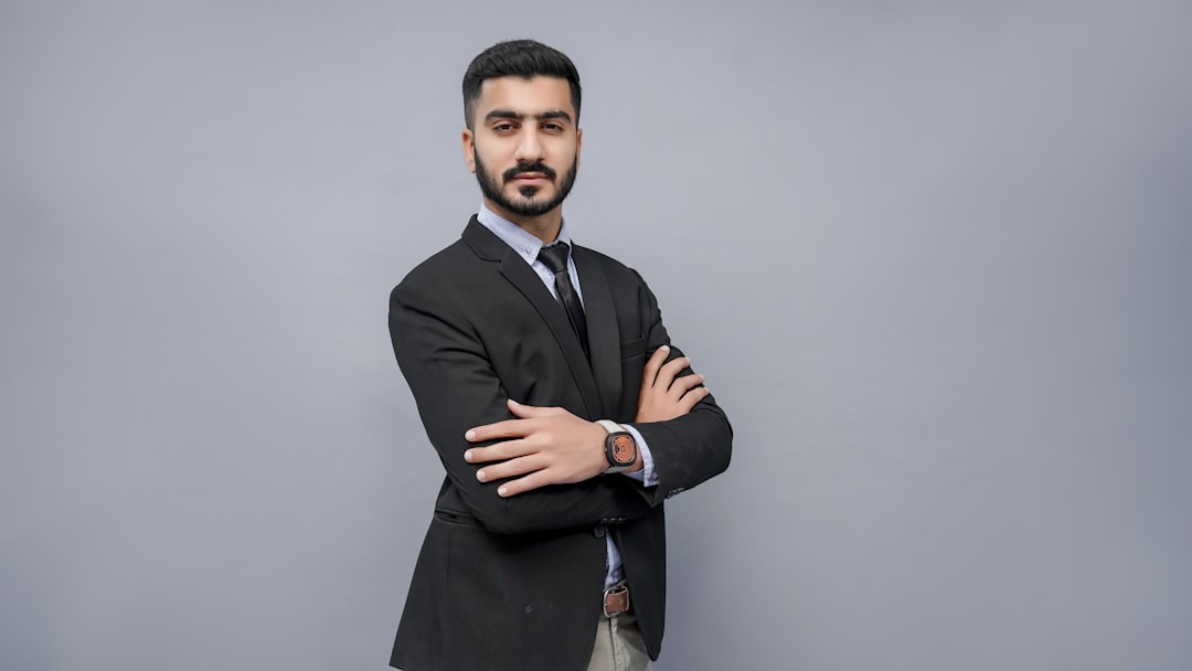 a man in a suit with his arms crossed