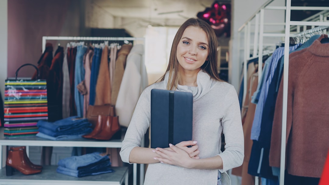 A woman stands in a clothing store.