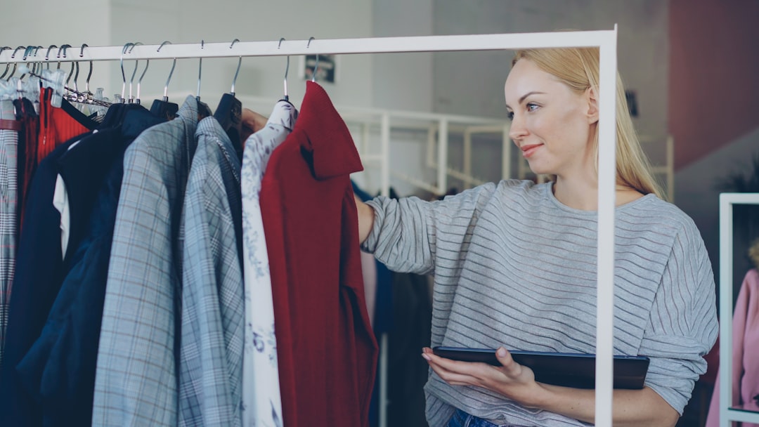 Woman looks at clothing on a rack.